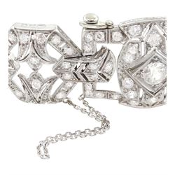 Continental Art Deco platinum milgrain set, old cut diamond openwork bracelet, circa 1920's, four rectangular shaped diamond panels each set with a principle diamond of approx 1.25 carat, 0.45 carat, 0.40 carat and 0.30 carat, the panels separated by chevron links and four leur de leys octagonal panels, total diamond weight approx 7.90 carat, makers mark IF, stamped 950, with shield hallmark, with insurance document, in original silk and velvet lined fitted box by G.Barichella, Nice-Vichy, France