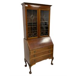 Edwardian walnut bureau bookcase, fitted with astragal leaded and glazed doors with tulip design, over fall-front with fitted interior, with three graduating drawers below, cabriole supports with ball and claw feet