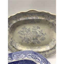 Four 19th century blue and white transfer printed meat plates decorated in the Willow pattern, together with an 'Asiatic Pheasant' pattern meat plate, largest L49cm (5) 