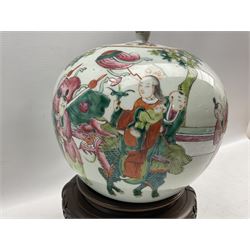 Chinese Famille Rose porcelain ginger jar and cover, of ovoid form painted in polychrome enamels with a procession of figures, with hardwood with four scroll supports, H22cm