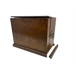 Late Victorian oak stationery box with hinged lid, divided interior, spring loaded drawer and fold out writing slope H32cm x W38cm