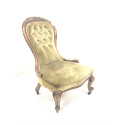 Victorian walnut nursing chair, spoon back with floral carved crest rail, upholstered in buttoned green crushed velvet, raised on scroll carved cabriole supports W59cm