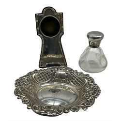 Modern silver bonbon dish with foliate, C scroll and lattice embossed sides, and personal engraving to centre, together with a silver mounted pocket watch stand, and two glass dressing table jars with silver covers