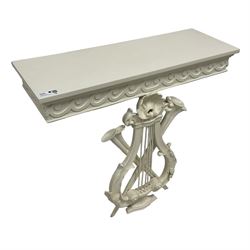 White painted console table, rectangular top over frieze with applied Vitruvian scroll, on shell and curled acanthus leaf decorated lyre support with crossed trumpets 
Provenance: From the Estate of the late Dowager Lady St Oswald