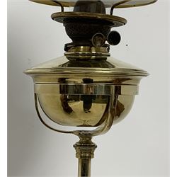 Art Nouveau brass floor standing oil lamp in the manner of W.A.S Benson, circa 1900, with opaque moulded glass shade, brass reservoir and adjustable knopped column  raised upon an swept openwork triform base with stylized feet, H186cm 