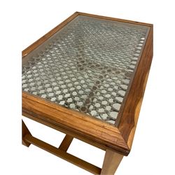 Rectangular hardwood and wrought metal centre table, inset glass top, raised on squared supports, united by stretchers 