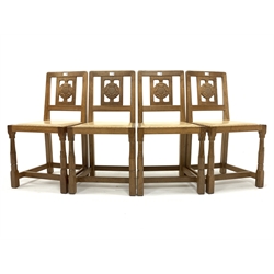 Set four 'Squirrelman' Yorkshire oak dining chairs, Yorkshire rose carved back panel over leather upholstered and studded seats, raised on octagonal turned supports united by 'H' stretcher, W45cm - Mouseman interest