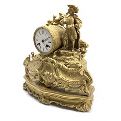 Late 19th century gilt metal figural mantel clock, the case surmounted by an artist flanking  a white enamel dial with Roman chapter ring, on a giltwood base decorated with conforming floral scrolls centred by cartouche W33cm