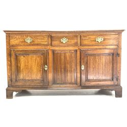 George III oak dresser base, three drawers over three panelled cupboards, raised on bracket supports W150cm, H86cm, D49cm