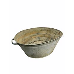 19th century riveted tin bath with drop carry handle to each end (L153cm) together with a similar foot bath (L75cm) and a bucket 