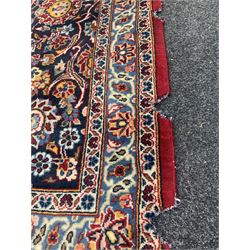 Persian hand knotted Tabriz ground carpet, red field centred by a deep blue medallion and decorated with trailing foliate, signed to border 320cm x 520cm