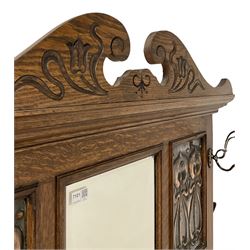 20th century oak hall stand,  one central mirror surrounded by hooks over umbrella stands and drip tray