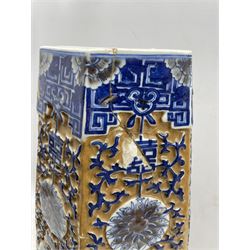 19th century Chinese porcelain ochre ground vase of swollen hexagonal form, decorated in relief with scrolling foliate lotus panels, bats, shou characters and fish, separated by a central band of chrysanthemums and stiff leaves to the base, seal mark beneath, H60cm 