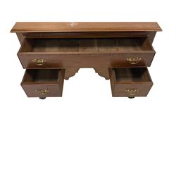 Georgian style mahogany low boy, the rectangular top with moulded edge, fitted with brushing slide with inset baize surface with reeded front, central frieze drawer over two short drawers, each cockbeaded and with crossbanding and brass handle pulls, the shaped apron raised on cabriole supports carved with acanthus leaves, terminating in ball and claw feet