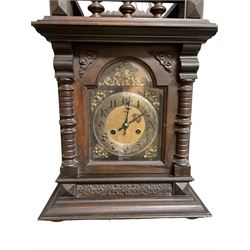 German - Edwardian oak cased 8-day mantle clock, with a raised pediment and gallery, break arch door with attached pilasters, resting on a stepped plinth, brass dial with spandrels, gothic steel hands, silvered chapter ring with Arabic numerals, rack striking movement striking the hours and half hours on a coiled gong. With   key and pendulum.