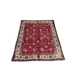 Persian rug from the Tabriz region, the red and floral field enclosed by green and ivory borders 346cm x 278cm