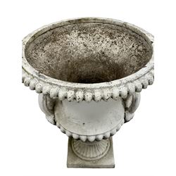 Pair white painted cast iron Campana shaped garden urns, gadroon moulded rim and underbelly, fitted with mask handles, on moulded stem and square base