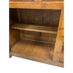 20th century oak sideboard, fitted with three drawers over two cupboard doors, opening to reveal one shelf, raised on stile supports 
