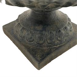 Early 19th century cast iron kylix garden urn, the rim decorated with acanthus leaf over shallow bowl with gadrooned underbelly, on footed base with foliate decoration 