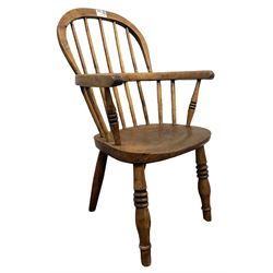 Childs Windsor armchair, the double hooped and spindle back over elm seat, raised on turned supports  