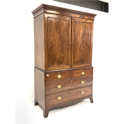 George III mahogany linen press, dentil cornice over two panelled doors embellished with ebonised and boxwood oval string inlay, enclosing three slides, two short and two long drawers under, shaped apron, raised on splayed bracket supports, W128cm, H209cm, D63cm