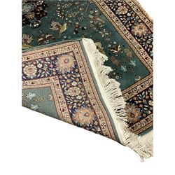 Persian teal ground rug, the field decorated with animal and bird motifs, floral design border with stylised plant motifs