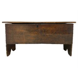 17th century oak six plank coffer, rectangular hinged top with incise carved edge, interior fitted with candle box, the front lightly carved with stylised rosettes