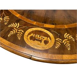 Mid-19th century Irish Killarney yew and arbutus wood breakfast table, the shaped tilt-top decorated with inlaid panels depicting various Killarney scenes including, Old Weir Bridge, Ross Castle and houses; decorated with foliage inlays and banding, octagonal faceted baluster pedestal on circular platform, inlaid with shamrocks and Celtic harps, three projecting carved paw feet with brass and ceramic castors