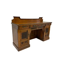 Late 19th century oak raised back sideboard, the rectangular top with moulded and ebonised edge over three frieze drawers and two cupboards carved with floral motifs, raised on a plinth base W180cm, H115cm, D60cm 