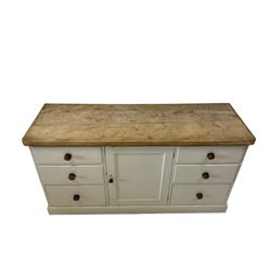 Victorian dresser base, the sycamore top over painted pine base with one central cupboard flanked by three graduated drawers, raised on a plinth base 