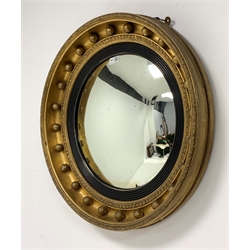 19th century circular gilt framed wall mirror, with convex plate enclosed by reeded ebonised slip, floral and beaded moulding to frame with applied ball decoration, D60cm