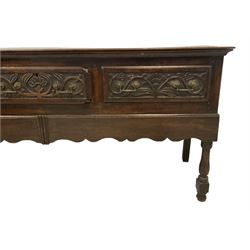 18th century oak dresser base, rectangular top with moulded edge, fitted with three drawers with scrolling foliate carved facias, shaped waived apron, raised on turned front supports