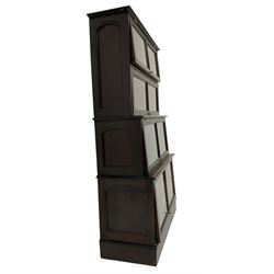 Early 20th century mahogany Globe Wernicke design stacking library bookcase, four tier, each enclosed by glazed up-and-over doors, on plinth base