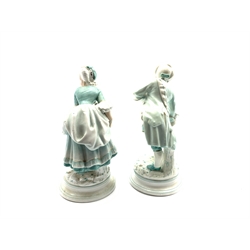  Pair of 19th Century porcelain male and female figures each holding a flower on blue lined circular bases possibly Milan San Cristoforo H19cm   