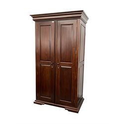 Barker & Stonehouse Grosvenor mahogany double wardrobe, projecting cornice over two panelled doors, enclosing interior fitting for hanging, raised on brackets, W111cm, H116cm , D65cm. 