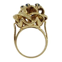 9ct gold open work flower design ring, set with seven round sapphires, London 1969