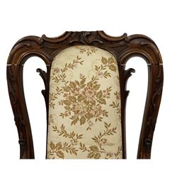 Pair of late 19th to early 20th century Anglo-Chinese hardwood open armchairs, C-scroll shell carved pediment over moulded frame decorated trailing foliage, the seat and back in pale ground floral pattern fabric, down swept arms with scroll carved terminals, on cartouche carved cabriole feet with scrolled foliage carved terminals  