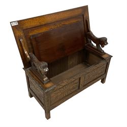 17th century design carved oak monks bench, metamorphic panelled top with foliate carvings, over box seat with hinged lid and lion arm terminals