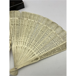19th century ivory silk and bone fan with pierced and decorated gorge and guards H24cm together with a pierced bone fan in black lacquer fan box