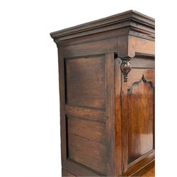 18th century oak housekeepers cupboard, projecting cornice over two panelled doors, fitted with three drawers over two cupboard doors enclosing single shelf, on stile feet 