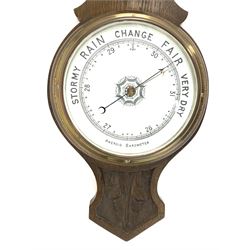 Edwardian carved oak aneroid wheel barometer and thermometer in banjo pattern case, with white porcelain registers 