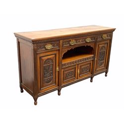Large Edwardian walnut sideboard, dentil frieze over three lunette carved drawers, open shelf and three cupboards with carved panels, raised on turned supports W184cm, H103cm, D54cm
