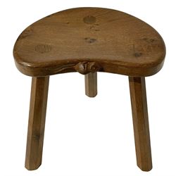 Mouseman - oak three-legged stool, figured dished kidney shaped top carved with mouse signature, on octagonal tapered supports, by Robert Thompson of Kilburn 