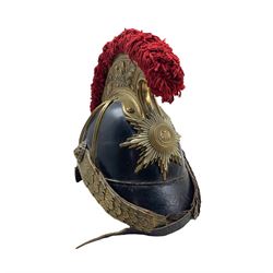 Imperial German Saxon  Model 1867 helmet, blackened leather skull with oak leaf embossed brass comb and red wool crest, brass flat chinscales, lion mask bosses, brass and white metal star helmet-plate mounted with a FJ cypher, H25cm 