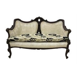 Early 20th century mahogany framed two seater sofa, upholstered in ivory fabric and with a floral seat pad 