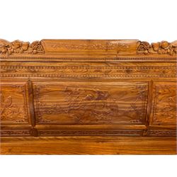 Chinese Imperial style hardwood throne room settee or sofa, the triple panelled back carved with dragon masks and birds in naturalistic landscapes, uprights fitted with two small drawers, on block supports, carved with scrolling foliate and traditional Chinese motifs
