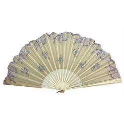 Early 20th century fan, the cream gauze leaf supported with bone ribs and guard, the gauze painted with lilac ribbons and sprigs, W67cm, Guard 35cm