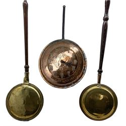 19th/ early 20th century copper pan later converted into a clock with repousse numerals and engraved fish decoration to the centre, D36cm excluding handle, together with two brass warming pans (3)