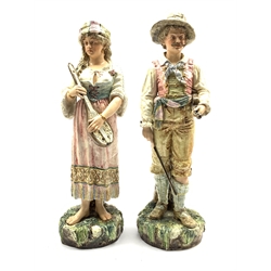 Pair of Continental Pottery standing figures of male and female musicians on naturalistic bases H50cm