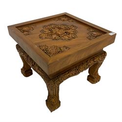 Indonisian carved hardwood table, the top carved with flower heads and foliage
